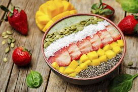 Spinach smoothie bowl with strawberries, coconut, mango, pumpkin seeds and seeds Chia. toning. selective focus