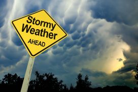 Stormy Weather Ahead Road Sign Against Dark Ominous Sky