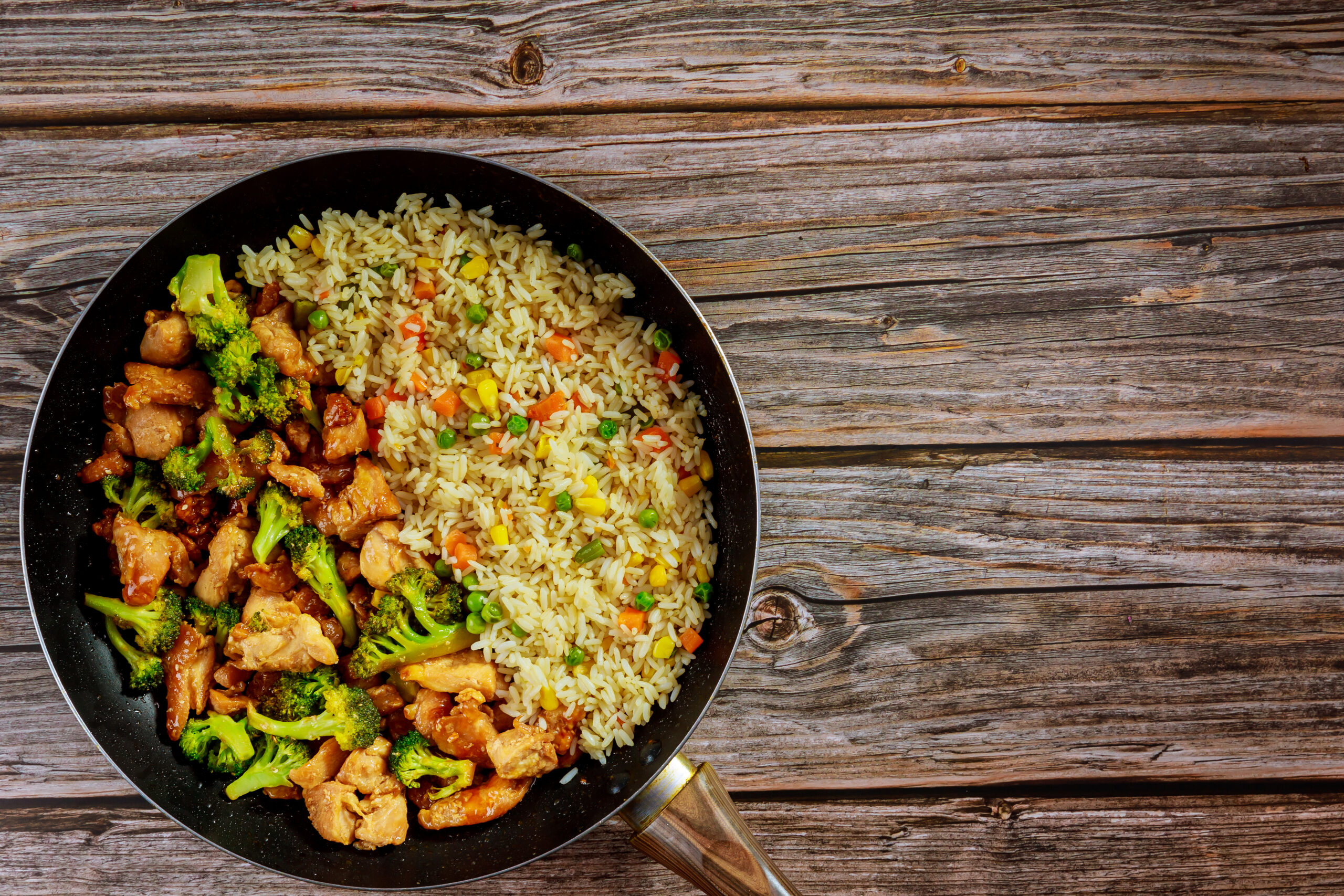 Stir-fry chicken with broccoli in sweet and sour sauce and rice. Asian meal.