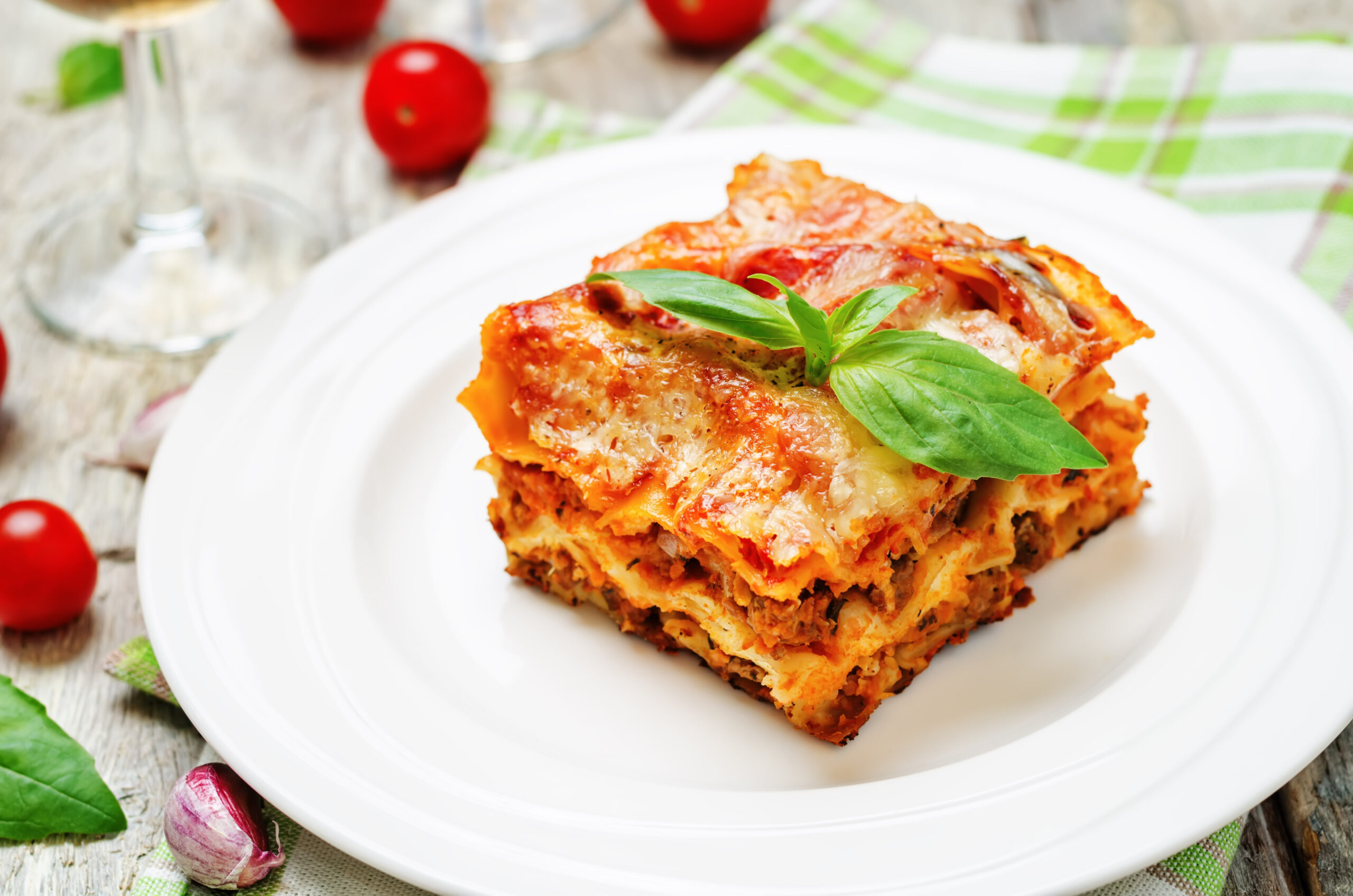 Meat lasagna on a white wood background. toning. selective focus